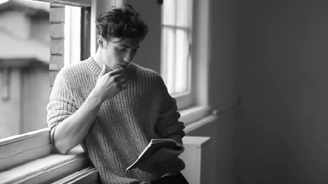 guy reads books deep in thought gif